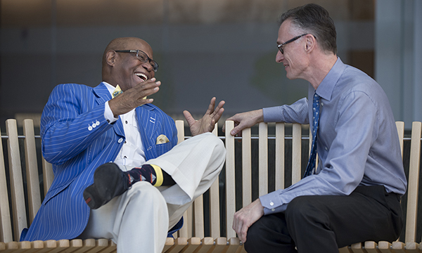 Willie Murphy laughing as he sits on a park bench and tells Jean Coumans a story Willie Murphy laughing as he sits on a park bench and tells Jean Coumans a story
